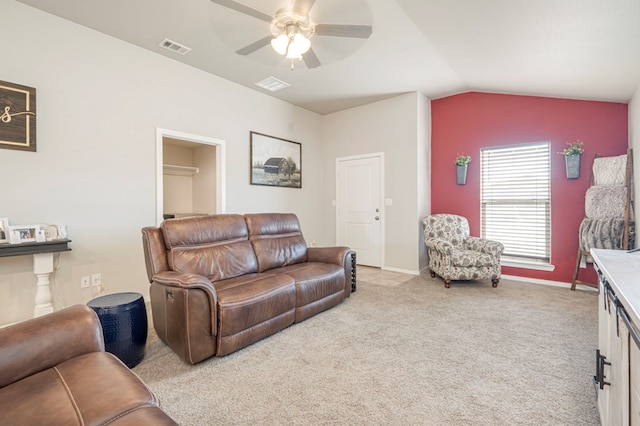 living room with lofted ceiling, light carpet, and ceiling fan