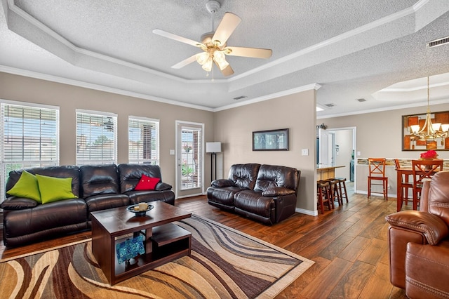 3834 Hyden Dr, Odessa, TX 79762 - living area featuring a raised ceiling, a ceiling fan, a fireplace, wood finished floors, and crown molding
