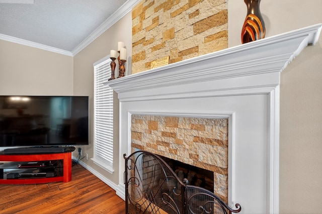 3834 Hyden Dr, Odessa, TX 79762 - living room with a textured ceiling, hardwood / wood-style floors, ceiling fan, crown molding, and a fireplace