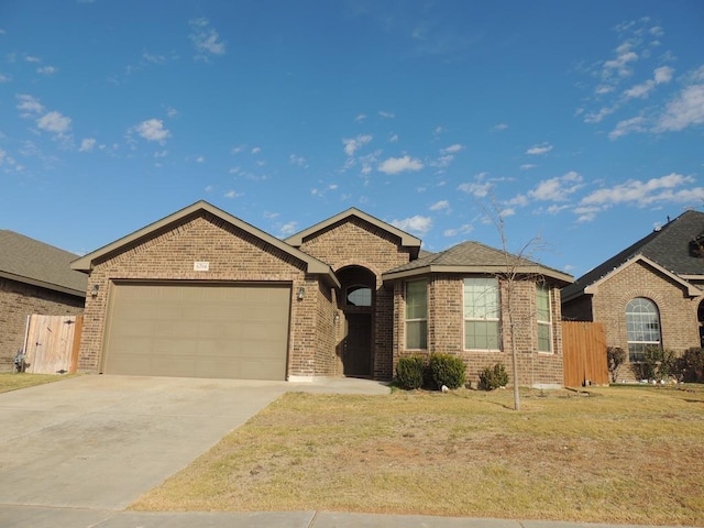 ranch-style home featuring a garage and a front lawn