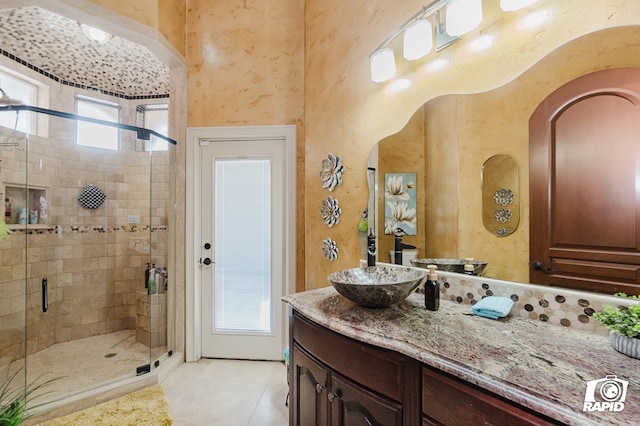 540 SE Loop 338, Odessa, TX 79766 - full bath featuring vanity, a shower stall, tile patterned flooring, and a textured wall