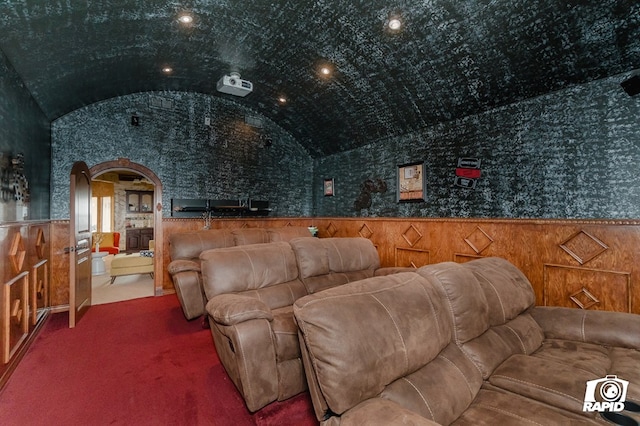 540 SE Loop 338, Odessa, TX 79766 - home theater room with arched walkways, vaulted ceiling, a wainscoted wall, and carpet floors