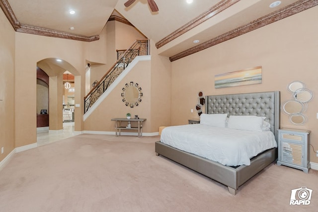 540 SE Loop 338, Odessa, TX 79766 - bedroom featuring arched walkways, crown molding, carpet flooring, lofted ceiling, and ceiling fan