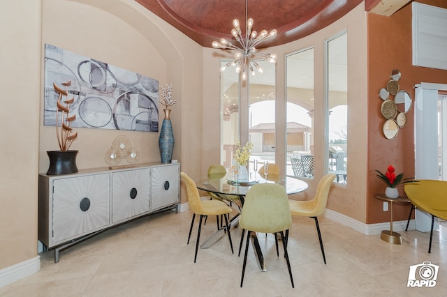 540 SE Loop 338, Odessa, TX 79766 - dining space with a chandelier, light tile patterned flooring, arched walkways, and a tray ceiling