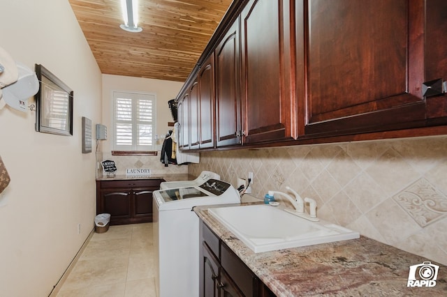 540 SE Loop 338, Odessa, TX 79766 - laundry room with cabinet space, wooden ceiling, washer and clothes dryer, and light tile patterned floors