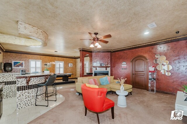 540 SE Loop 338, Odessa, TX 79766 - living room featuring arched walkways, ceiling fan, ornamental molding, and a textured ceiling