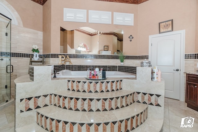 540 SE Loop 338, Odessa, TX 79766 - full bathroom with tile walls, a bath, a shower stall, and vanity