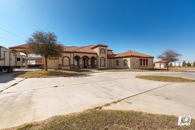 540 SE Loop 338, Odessa, TX 79766 - mediterranean / spanish-style home with curved driveway and stucco siding