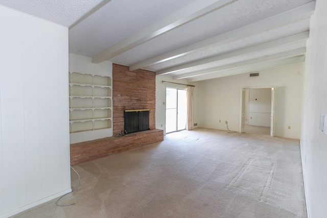 2608 E 24th St, Big Spring, TX 79720 - unfurnished living room with beam ceiling, a fireplace, carpet, and a textured ceiling