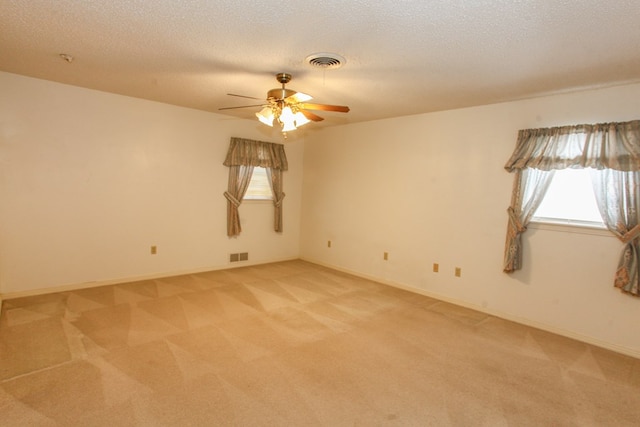 2608 E 24th St, Big Spring, TX 79720 - empty room with plenty of natural light, light carpet, a ceiling fan, and a textured ceiling