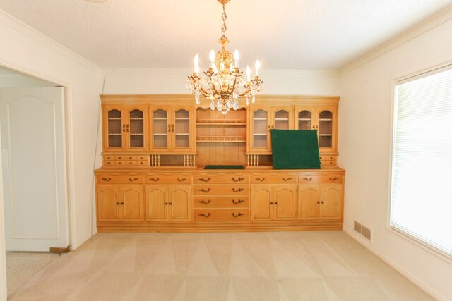 2608 E 24th St, Big Spring, TX 79720 - unfurnished dining area featuring a chandelier, light carpet, and crown molding