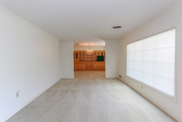 2608 E 24th St, Big Spring, TX 79720 - unfurnished room featuring a chandelier and light carpet
