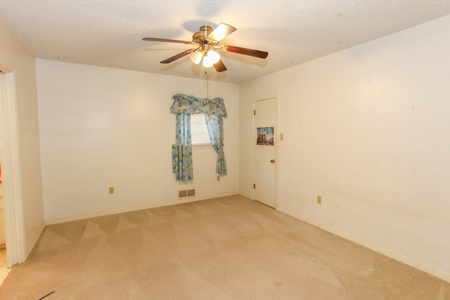 2608 E 24th St, Big Spring, TX 79720 - unfurnished room with light colored carpet, ceiling fan, and a textured ceiling