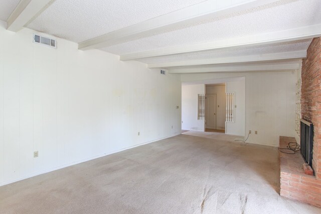 2608 E 24th St, Big Spring, TX 79720 - unfurnished living room featuring beam ceiling, a brick fireplace, carpet, and a textured ceiling