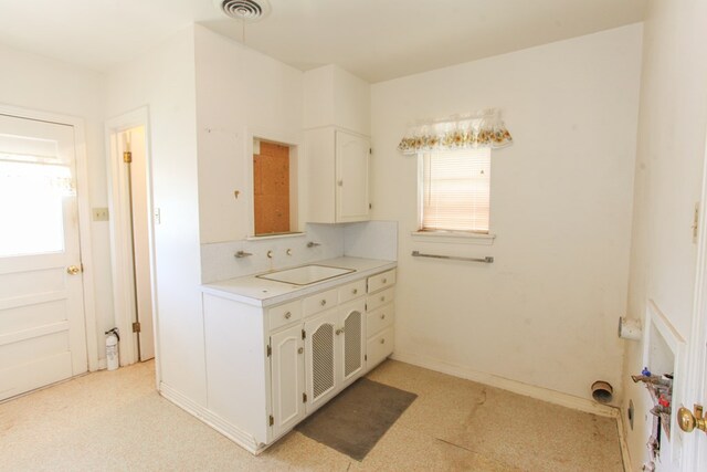 2608 E 24th St, Big Spring, TX 79720 - kitchen with plenty of natural light, white cabinets, and light countertops