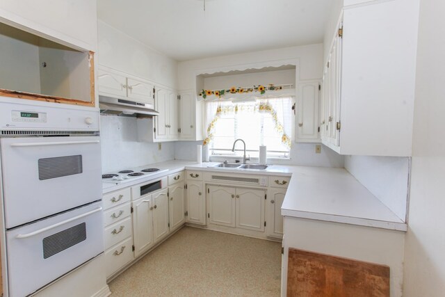 2608 E 24th St, Big Spring, TX 79720 - kitchen with white appliances, under cabinet range hood, and light countertops
