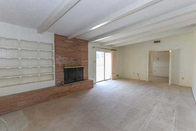 2608 E 24th St, Big Spring, TX 79720 - unfurnished living room featuring carpet, beamed ceiling, a brick fireplace, and a textured ceiling