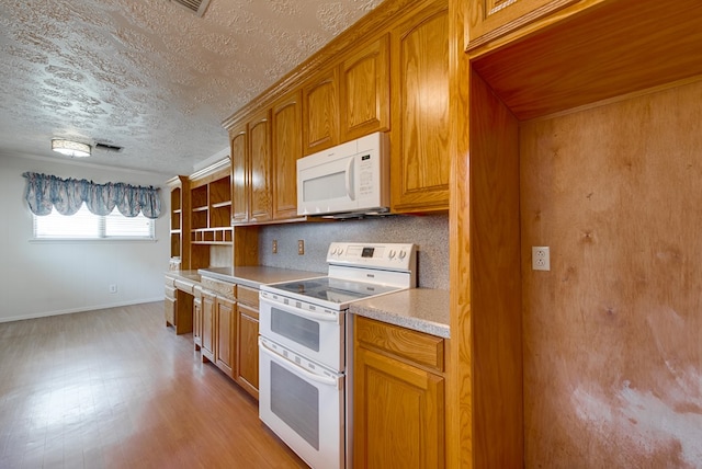 kitchen featuring white appliances, a textured ceiling, decorative backsplash, light hardwood / wood-style flooring, and crown molding