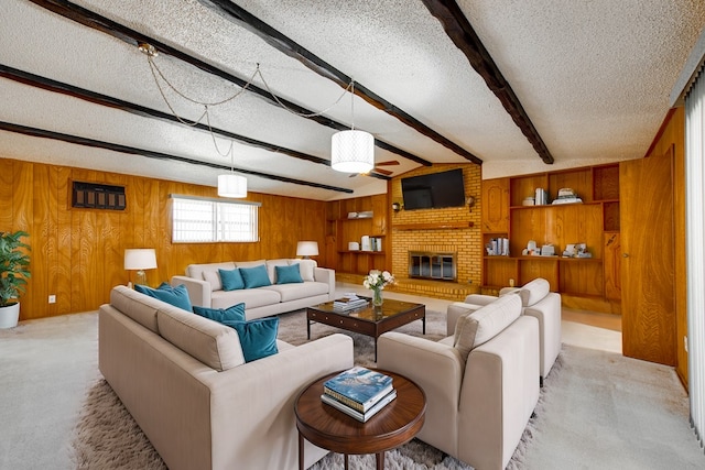 living room with a fireplace, beamed ceiling, wooden walls, and a textured ceiling