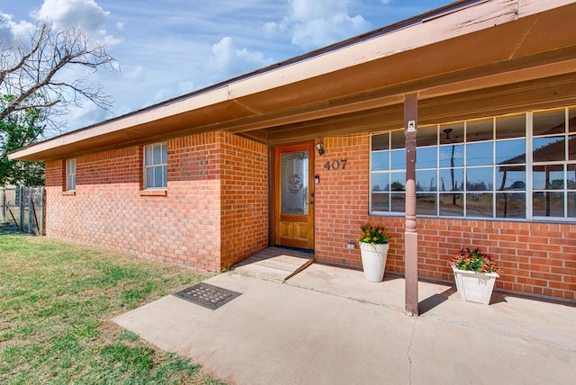 view of exterior entry with a porch