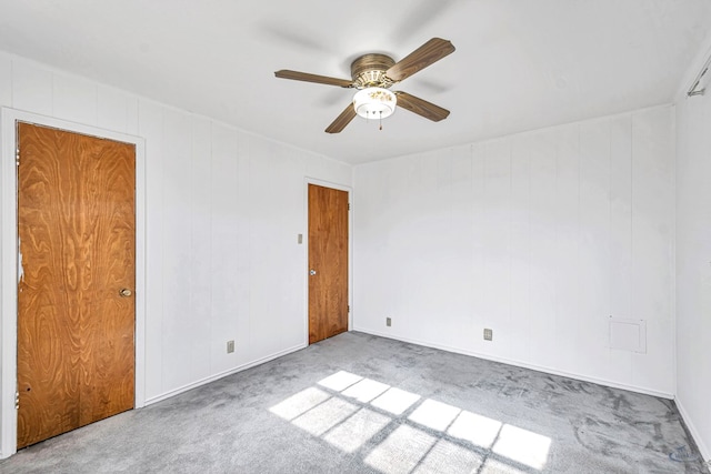 unfurnished room with light colored carpet and ceiling fan