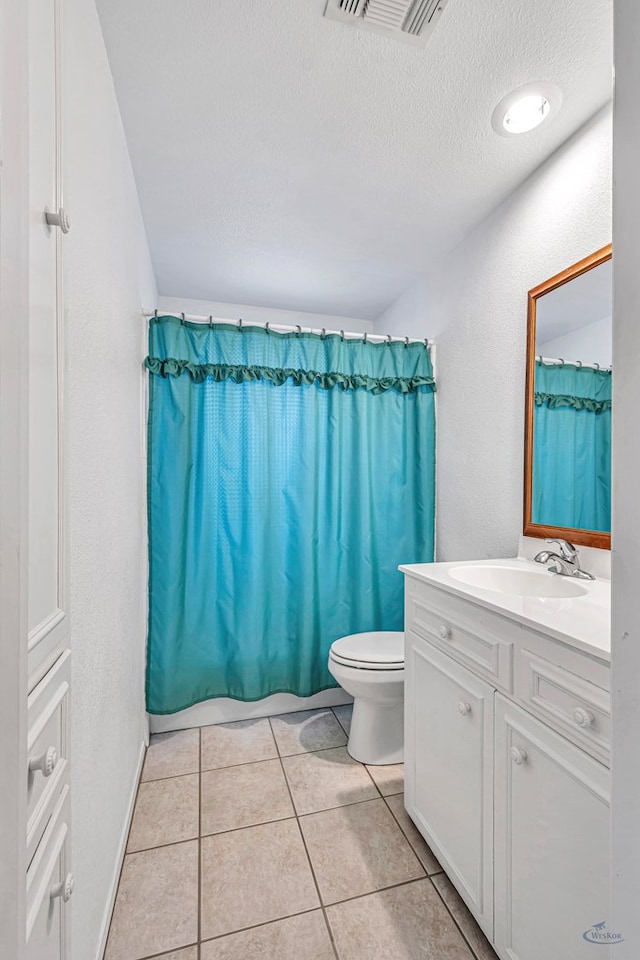 full bathroom with vanity, tile patterned flooring, toilet, shower / bathtub combination with curtain, and a textured ceiling