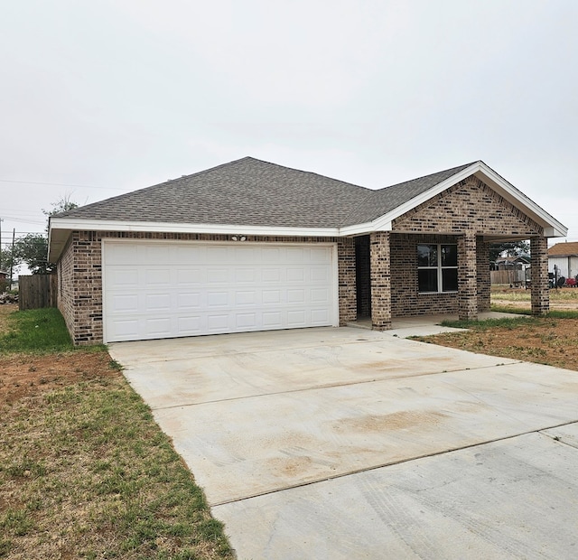 508 E Estes Ave, Midland, TX 79701 - view of front of property featuring brick siding, driveway, a garage, and roof with shingles
