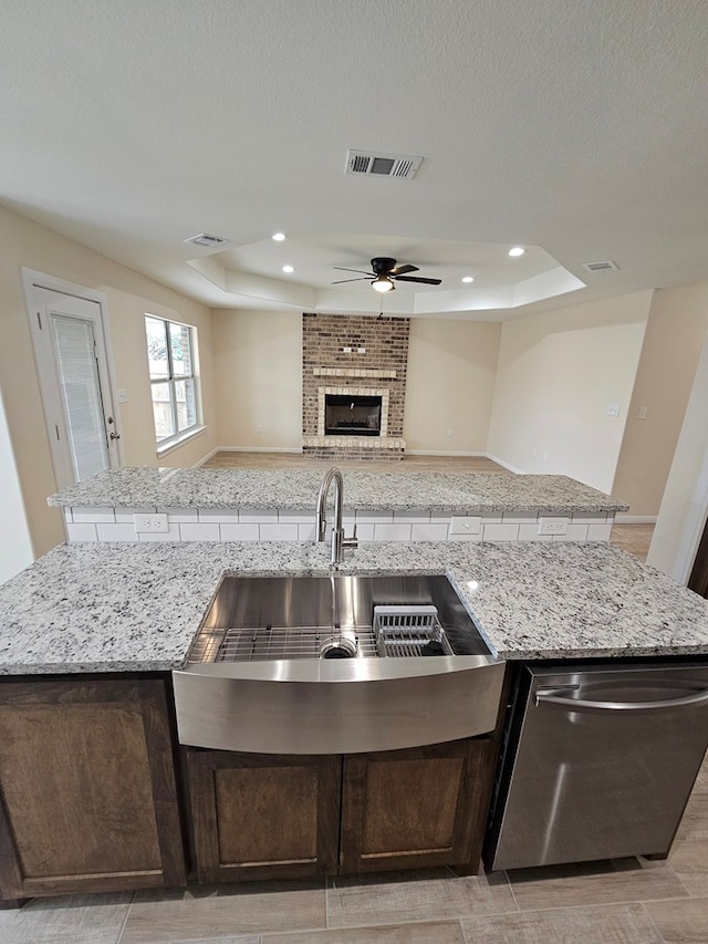 508 E Estes Ave, Midland, TX 79701 - kitchen featuring a raised ceiling, open floor plan, an island with sink, stainless steel dishwasher, and recessed lighting