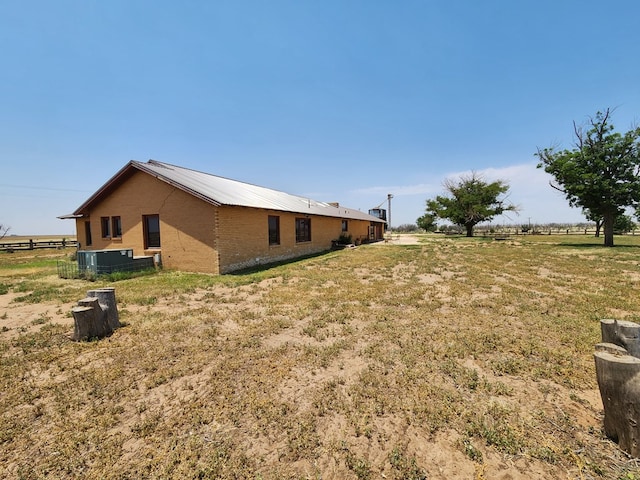 view of yard with a rural view and cooling unit