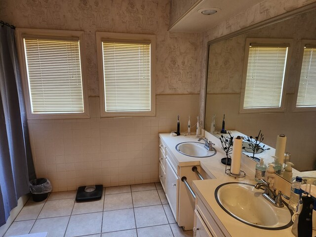 bathroom with tile patterned flooring, vanity, and tile walls