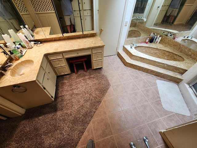 bathroom featuring tile patterned floors, vanity, and a bath