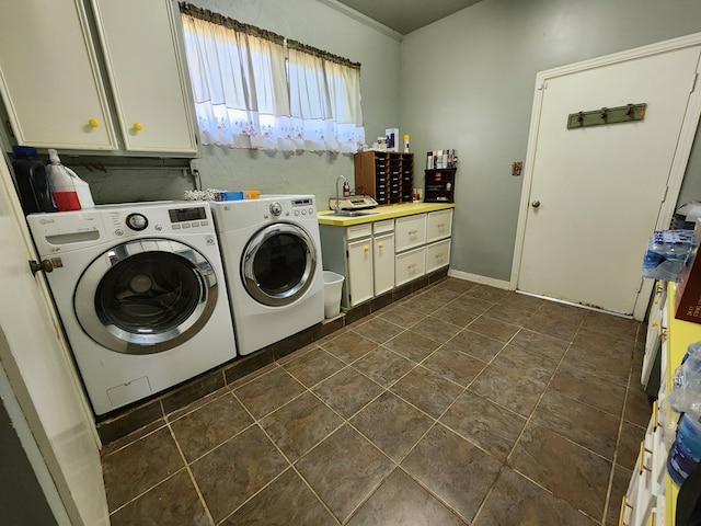 laundry room with cabinets, separate washer and dryer, dark tile patterned flooring, and sink