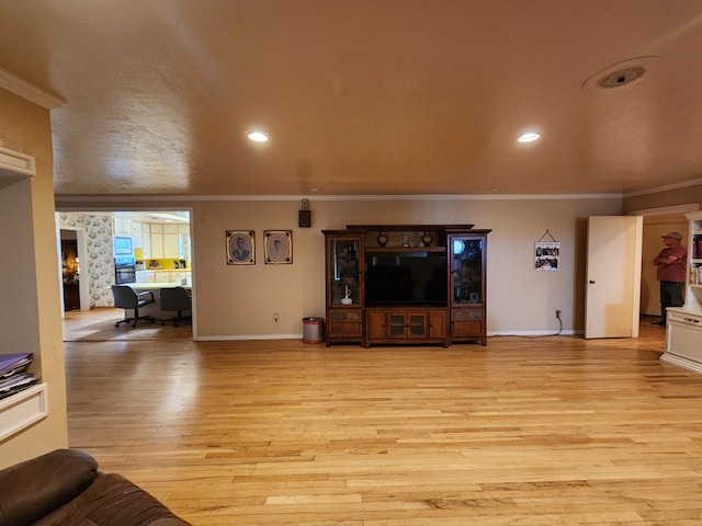 living room featuring light hardwood / wood-style floors and ornamental molding