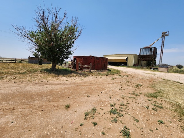 view of yard featuring a rural view and an outdoor structure