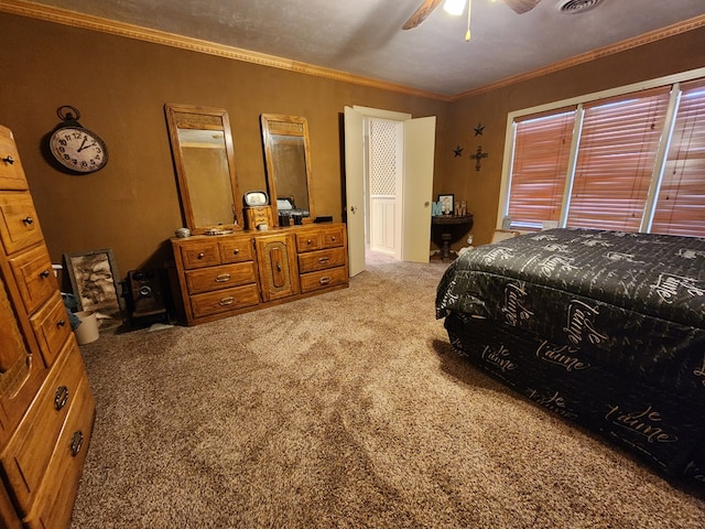 carpeted bedroom featuring ceiling fan and crown molding