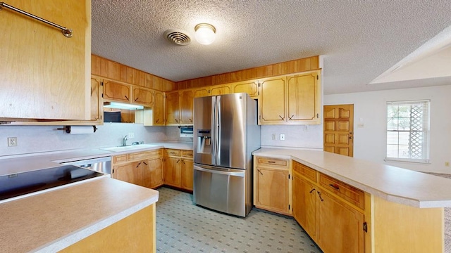309 Edgewood Dr, Midland, TX 79703 - kitchen featuring stainless steel refrigerator with ice dispenser, a peninsula, a textured ceiling, light countertops, and dishwasher