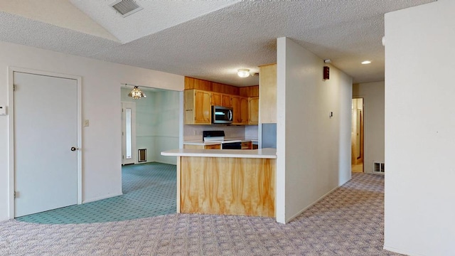 309 Edgewood Dr, Midland, TX 79703 - kitchen featuring stainless steel microwave, electric range oven, light carpet, light countertops, and a peninsula