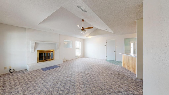 309 Edgewood Dr, Midland, TX 79703 - unfurnished living room with ceiling fan, carpet, lofted ceiling, a fireplace, and a textured ceiling