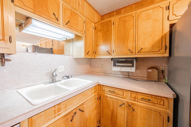 309 Edgewood Dr, Midland, TX 79703 - kitchen with tasteful backsplash, light countertops, a textured ceiling, and freestanding refrigerator