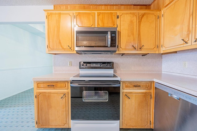 309 Edgewood Dr, Midland, TX 79703 - kitchen with stainless steel appliances, light countertops, carpet flooring, and a textured ceiling
