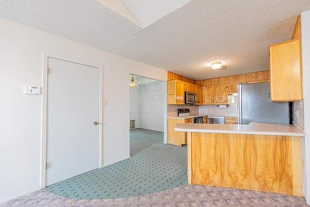 309 Edgewood Dr, Midland, TX 79703 - kitchen with appliances with stainless steel finishes, light colored carpet, light countertops, a peninsula, and a textured ceiling
