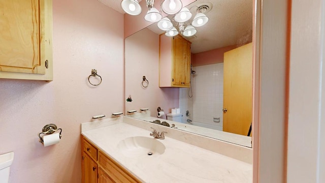 309 Edgewood Dr, Midland, TX 79703 - full bathroom with vanity, a textured ceiling, a chandelier, and bathtub / shower combination