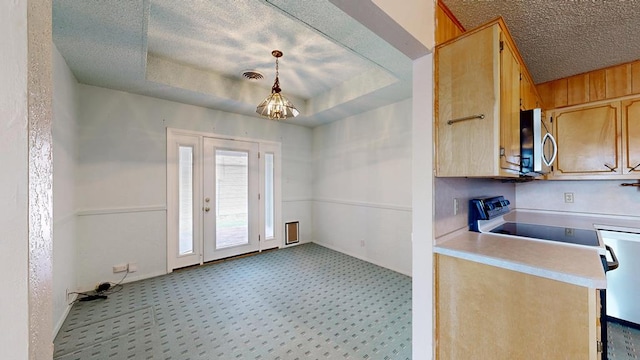 309 Edgewood Dr, Midland, TX 79703 - kitchen with stainless steel microwave, light countertops, a chandelier, light carpet, and a textured ceiling