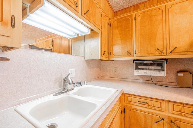 309 Edgewood Dr, Midland, TX 79703 - kitchen featuring light countertops, decorative backsplash, and a textured ceiling