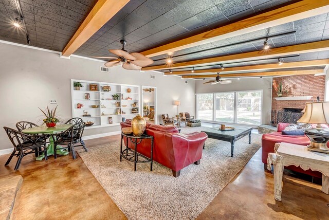 1600 W Kansas, Midland, TX 79701 - living room with a ceiling fan, concrete floors, beam ceiling, a brick fireplace, and baseboards