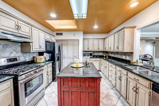 1600 W Kansas, Midland, TX 79701 - kitchen with stainless steel appliances, under cabinet range hood, a sink, light tile patterned floors, and recessed lighting