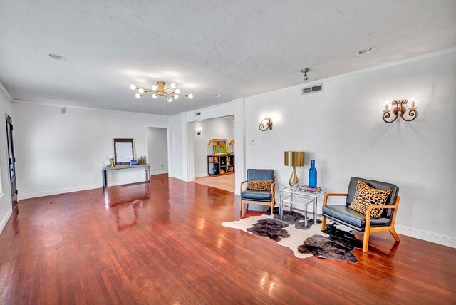 1600 W Kansas, Midland, TX 79701 - living area featuring wood finished floors, a chandelier, baseboards, and ornamental molding