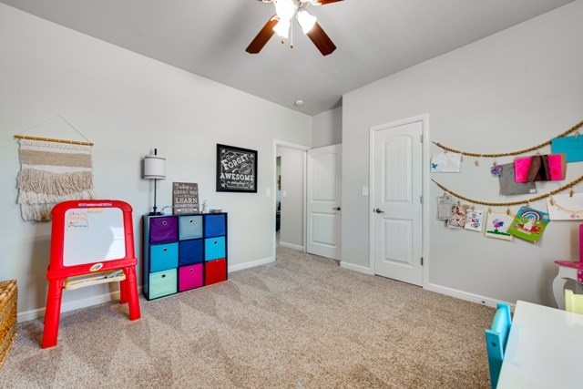 playroom with baseboards, carpet floors, and ceiling fan