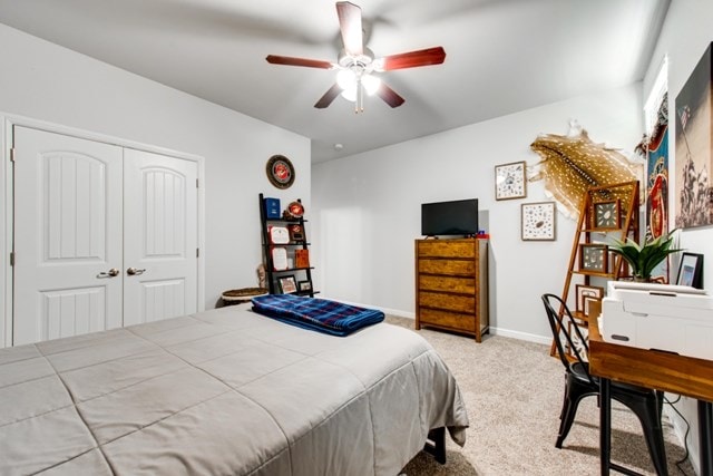 bedroom featuring a closet, light carpet, baseboards, and ceiling fan