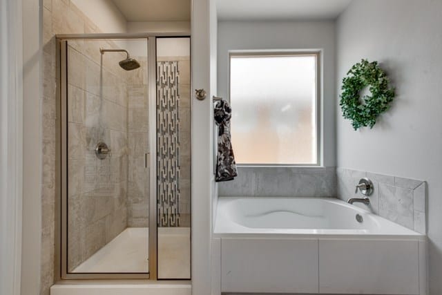 full bath featuring a shower stall and a garden tub